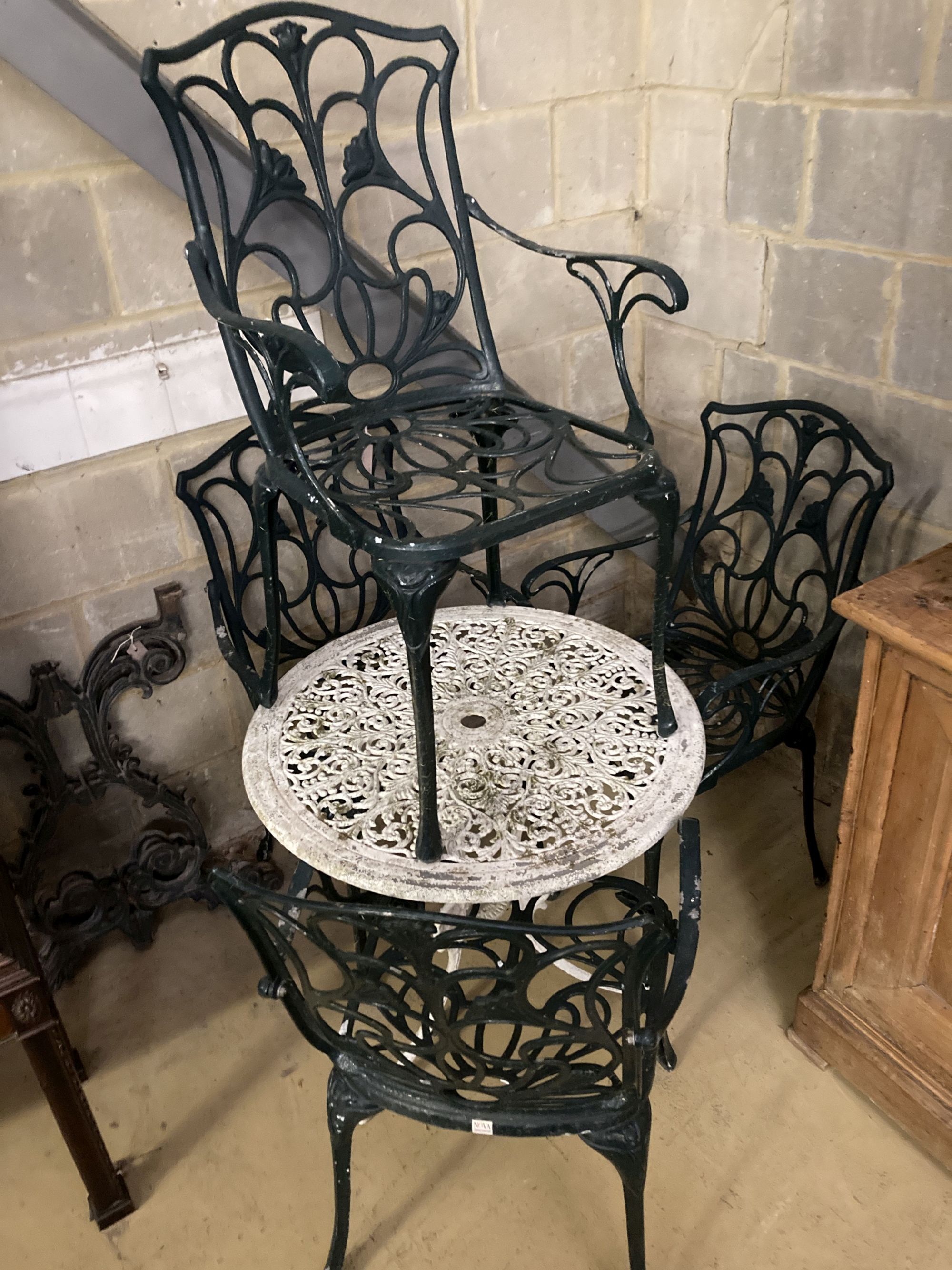 A Victorian style painted circular aluminium garden table, 68cm diameter together with a set of four painted aluminium garden elbow cha